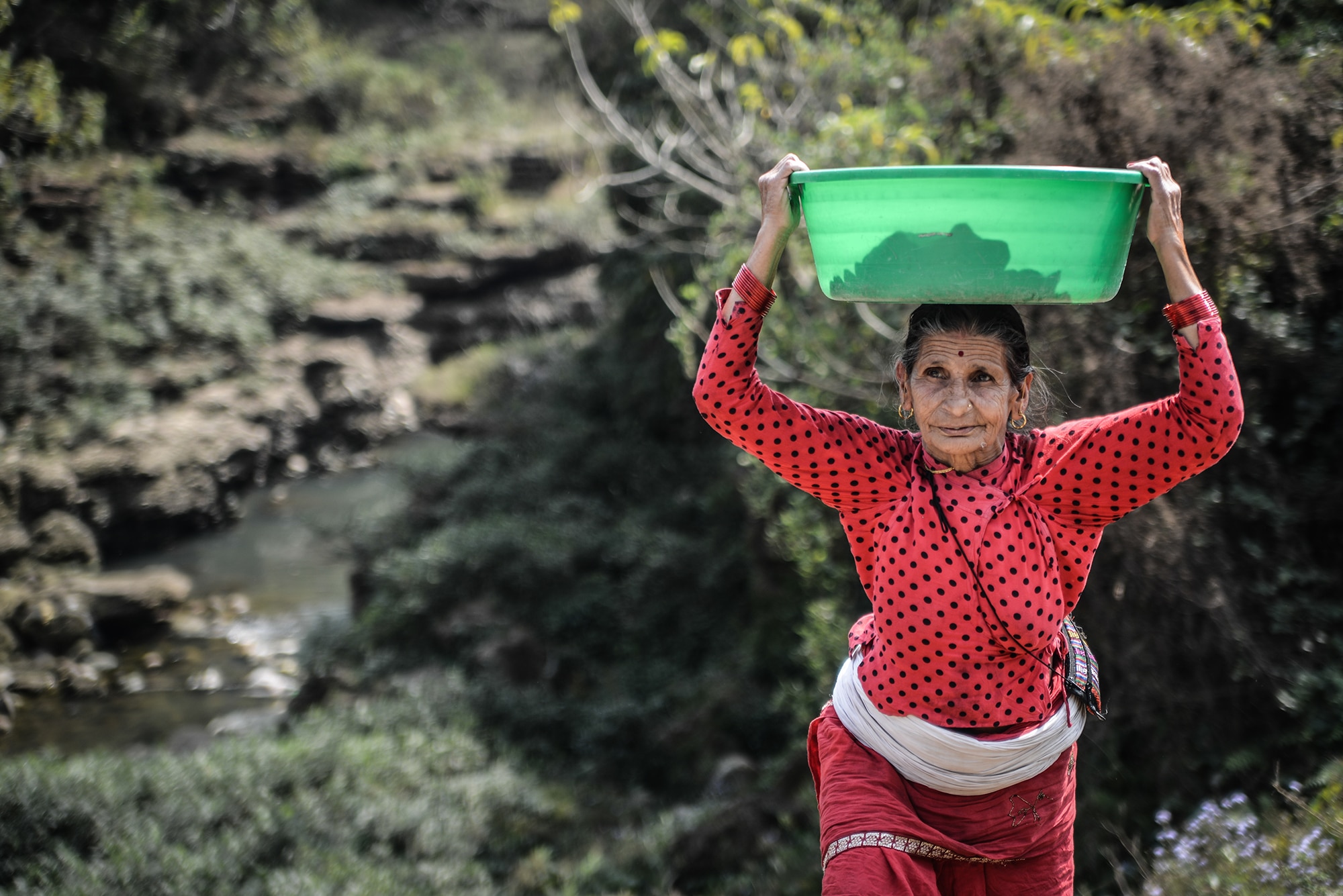 femme qui porte une basssine à Pokhara au Népal